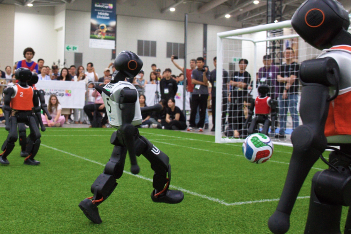 A B-Human robot carrying out a long forward kick